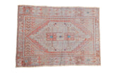 Vintage distressed Oushak rug with a stepped diamond medallion in pale burnt orange, ivory, and dusty turquoise.