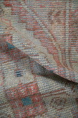 A soft fold revealing the distressed low pile and hand-knotted texture of a vintage Turkish rug.