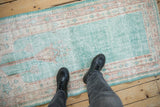 Distressed vintage Oushak runner showing even wear, ocean green, ivory, and terracotta hues.