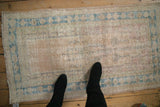 Vintage Distressed Oushak Rug, highlighting decorative wear on prayer motif and floral borders.