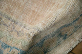 Distressed hand-knotted Oushak rug with softened cream and muted sky blue pile.