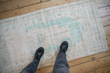 Faded ocean green and cream distressed Oushak rug runner pile with vine motif.
