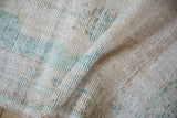 Distressed Oushak runner texture with visible wear, featuring cream and ocean green.