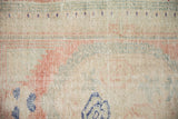 Close-up of a distressed Turkish Oushak rug's weave showing wear across the knot heads.