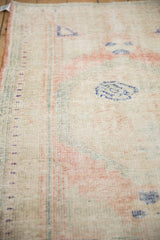 Worn knot heads and the intact side cord selvage of a vintage Turkish Oushak rug.