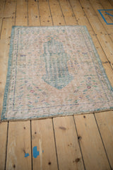 Distressed vintage Oushak rug with a pale turquoise central medallion and worn germinating seed motifs.