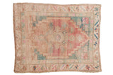 Distressed vintage Oushak square rug, central medallion, pink, dusty turquoise, and beige.