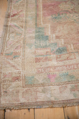 Distressed Oushak rug detail: worn pile, faint foundation, intact selvage, muted colors.