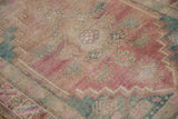 Oushak rug pile, even wear, pink, dusty turquoise, and beige floral patterns.