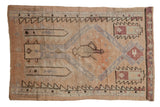 Distressed Vintage Oushak rug, geometric prayer-jug motif in soft cantaloupe, blush, and muted blue.