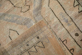 Folded vintage Oushak rug revealing its reverse foundation, secured side, and textured pile.