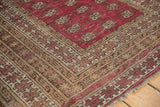 Anatolian rug corner with heavy abrash, brown checkered pound borders, and contoured edge.