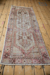 Vintage distressed Oushak rug with worn coral, cream geometric patterns.