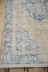 Intact side cord on a distressed Oushak rug, showing the low pile and hand-knotted texture.