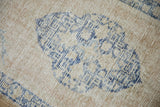 Worn, hand-knotted pile of a vintage Oushak rug showing its cream and cobalt blue foundation.