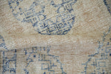 A folded view revealing the low pile and hand-knotted texture of a vintage Oushak rug.