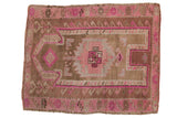 Distressed vintage Kars square rug featuring a pink, magenta, and brown prayer motif with serrated palmettes. 3'4