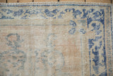 Close-up of a vintage Oushak rug's hand-knotted pile, showing mostly even, time-softened wear.