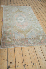 Vintage Distressed Oushak rug, serrated medallion and border, muted rose and bronze.