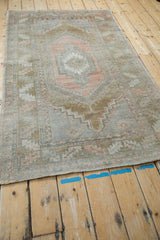 Distressed vintage Oushak rug detail with faded abrashed dusty rose and slate blue.