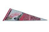 Iconic red winged wheel logo and bold team lettering on a vintage felt pennant.
