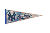 Vintage New York Yankees felt pennant, blue logo, orange baseball stitching, 12x30 inches.