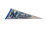 Blue Yankees lettering and orange baseball stitching on a vintage felt pennant.