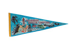 Blue felt Johnson Space Center pennant with retro illustrations of the space shuttle, astronauts, and moon landing.