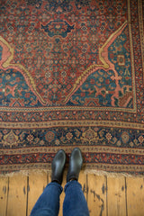Close-up of the frayed fringe and intricate border on a vintage Persian area carpet.