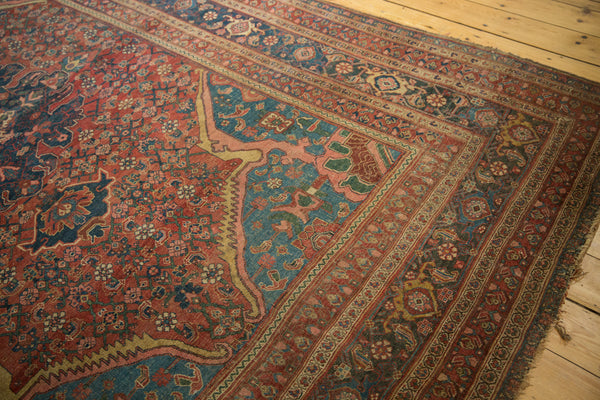 Corner detail of an antique Persian rug showing sprawling spandrels and multi-layered borders.