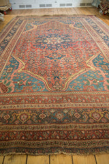 Antique Persian area rug showing its intricate pattern and rich colors from a low angle.