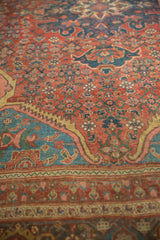 Angled view across the rich floral patterns and spandrels of an antique Persian rug.