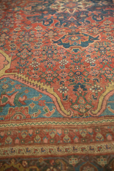 Angled view across the rich floral patterns and spandrels of an antique Persian rug.