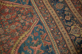 Close-up view of the corner spandrel and intricate borders on an antique Persian Bijar carpet.
