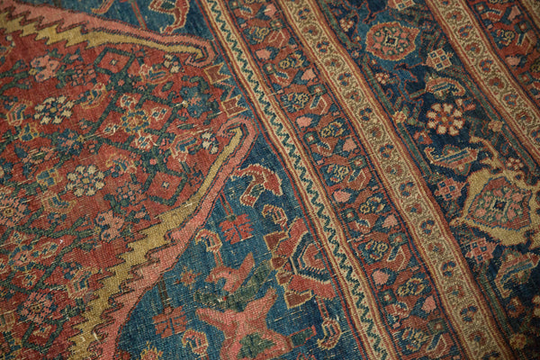Close-up view of the corner spandrel and intricate borders on an antique Persian Bijar carpet.
