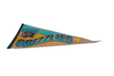 Angled vintage Vancouver Grizzlies felt pennant, displaying creases and mild discoloration.
