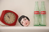 Mid-Century ceramic lady's head with black hair, rosy cheeks, and visible vintage wear.