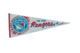 Vintage New York Rangers triangular felt pennant, red, white, blue logo, visible seam, 12x30 inches.