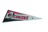 Vintage Vancouver Canucks felt pennant with its classic skate logo viewed from an angle.