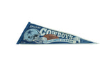 Vintage Dallas Cowboys felt pennant, with aged blue tones and visible champion text detail.