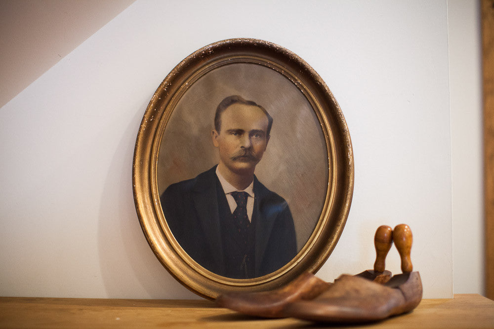 Vintage painted portrait of a gentleman with a mustache, set in a weathered oval gold frame.