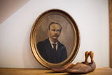 Vintage painted portrait of a gentleman with a mustache, set in a weathered oval gold frame.
