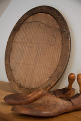 Penciled inscription 'Alice's Father' on the aged cardboard back of the vintage oval portrait frame.