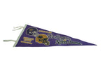 Vintage purple felt pennant detail: white ties, vertical edge, and stadium text.