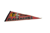 An angled view of the entire vintage Chicago Blackhawks felt pennant.