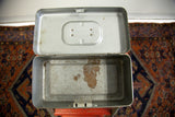 Overhead view of the open gray tool box showing its industrial, rusted interior.