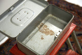 Aged patina and rust visible inside the open vintage metal box.
