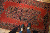 Overhead view for scale of the 4x6 Antique Tomato Red Malayer Rug with its detailed dark blue Herati medallion.