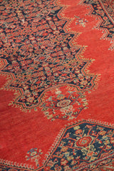 Close-up of the Herati motif medallion on a 4x6 antique tomato red Malayer rug.