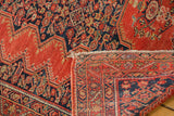 Folded corner detail of antique tomato red Malayer rug showing front pile and back weave.